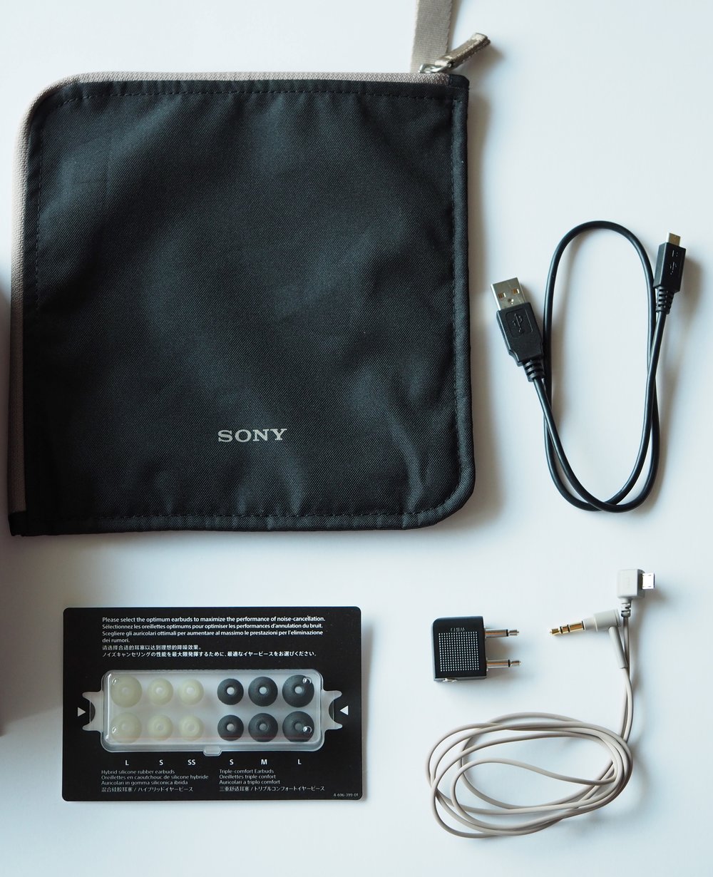 Clockwise from top left: Pouch, Micro-USB cable, 3.5mm to Micro-USB cable, Inflight Adapter, Earbuds